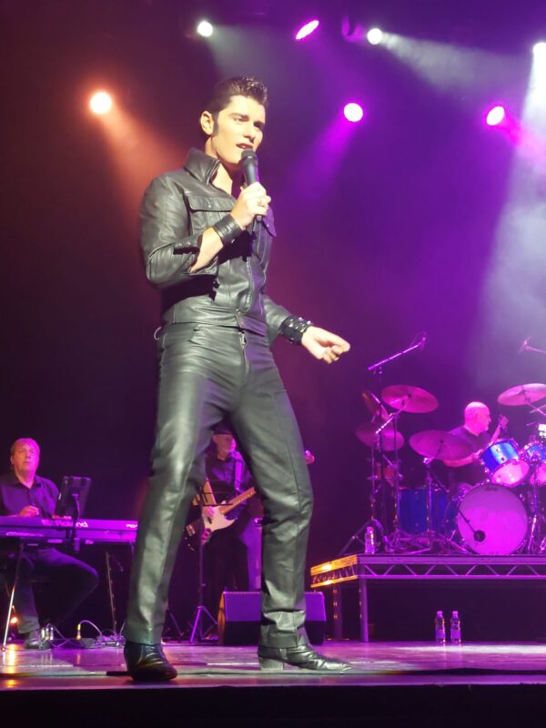 WEARING HIS LEATHER JACKET AND TROUSERS