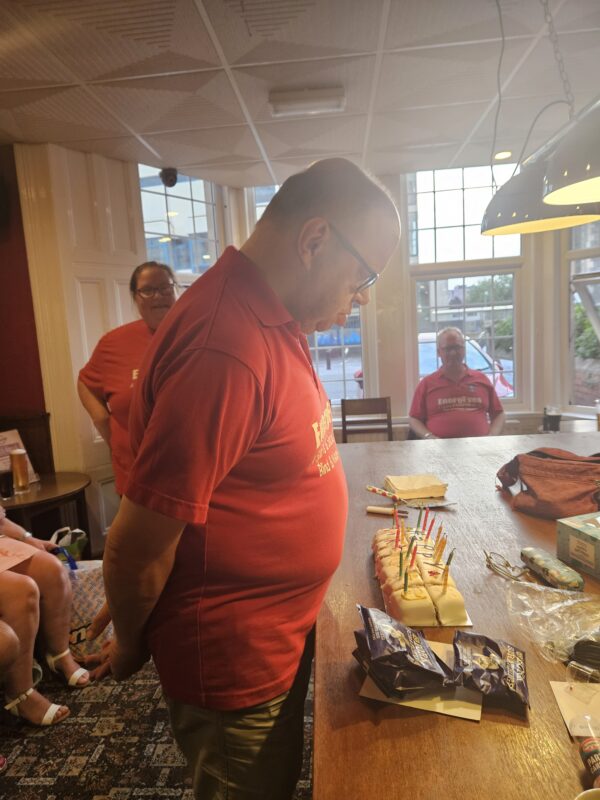 JAMES DERRICK BLOWING HIS CANDLES OUT FOR HIS 50TH BIRTHDAY PARTY